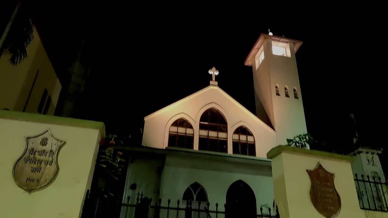 A stunning tilt-down night shot of St. John the Baptist Church in Thane, Maharashtra. The church glows softly under warm lighting.