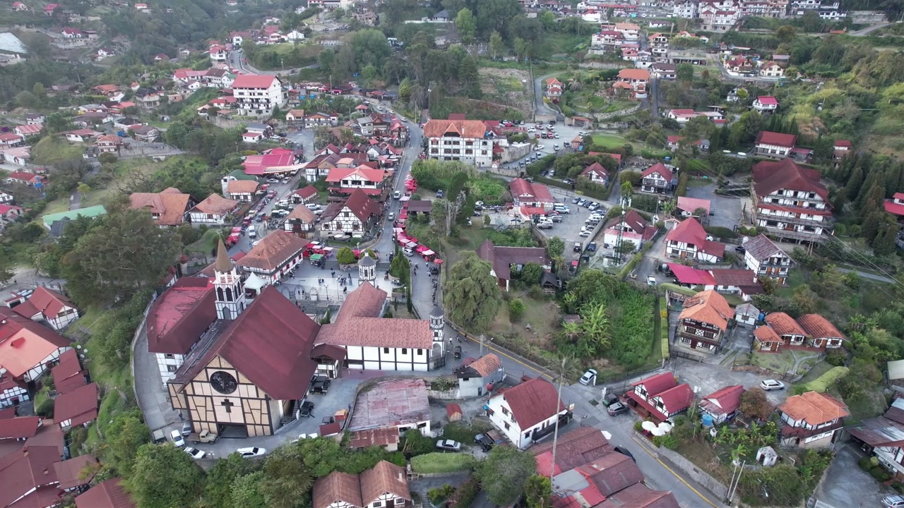 Drone pull back over German-style mountain town in Venezuela. High dynamic range 4K Log footage for professional color grading.