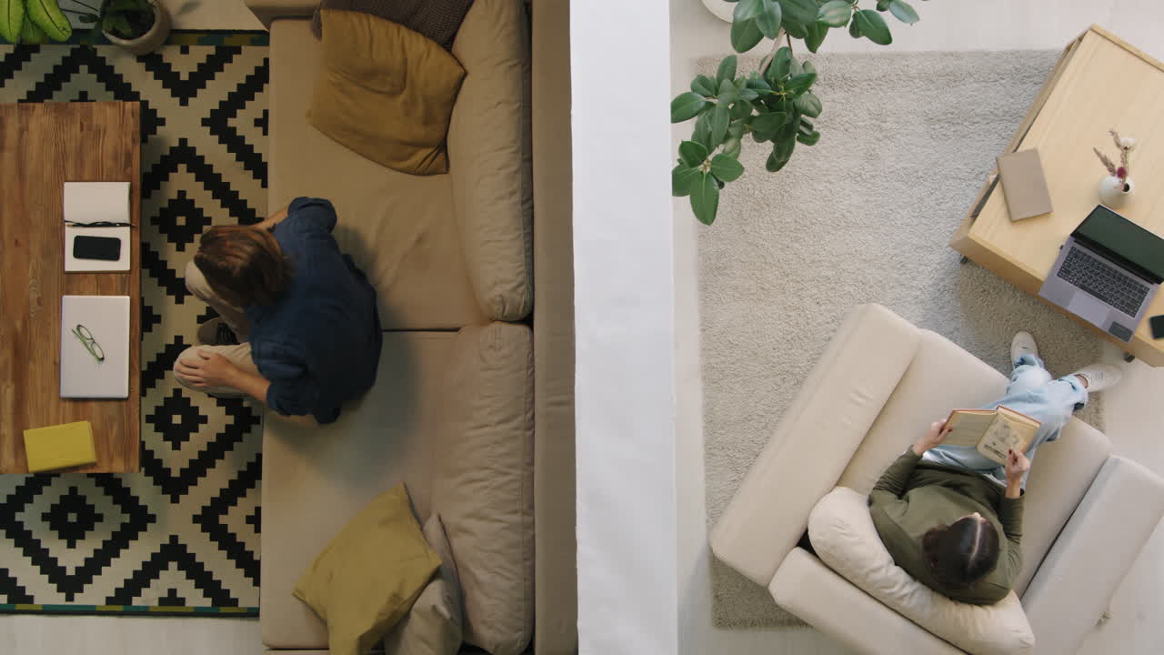 Overhead view of people relaxing and working in a modern living room