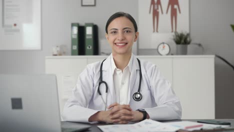 happy indian female doctor looking at the camera