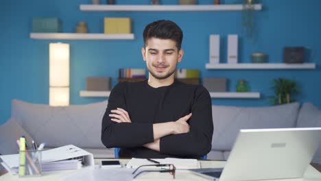 Happy-and-relaxed-home-office-worker-businessman-smiling-at-camera.