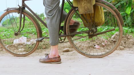 young man leg peddling bicycle in the village at lang son city, vietnam