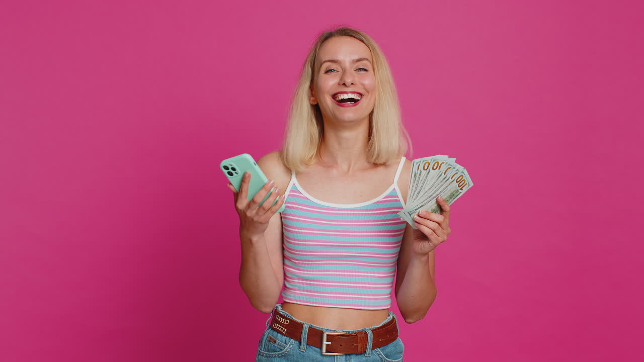 Happy woman use smartphone rejoicing game win, receiving money dollar cash, celebrating success