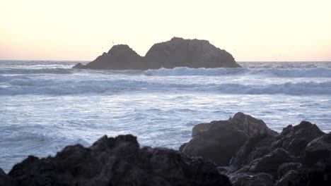 sunset, waves, and rocks in the sea