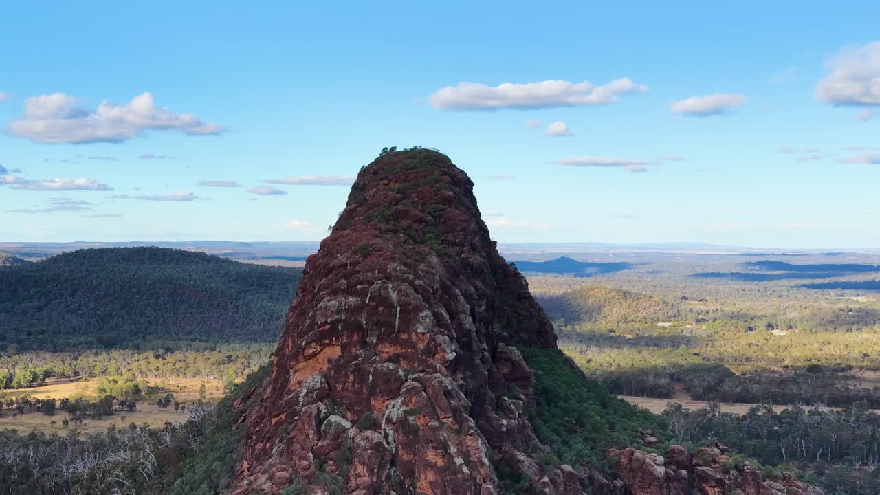 Drone smoothly flies over Timor Rock, revealing vast Australian landscape under bright daylight