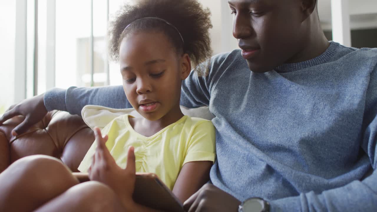 Video of african american father and daughter talking and playing