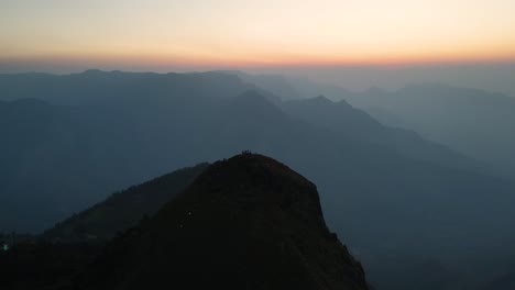 aerial drone shot of kolukkumalai range with morning light highlighting the hills