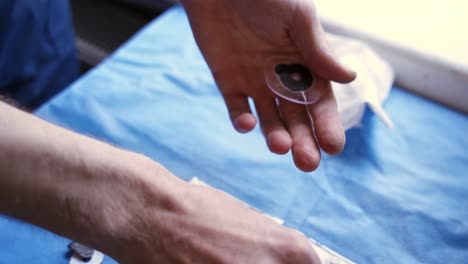 technician making spectacles. man's hands producing lens for eyeglasses in the laboratory. vision concept.