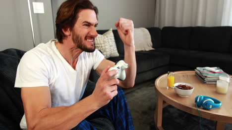 man playing video games in living room