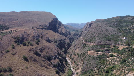 Aerial-moving-into-the-Topolia-Gorge,-Crete,-Greece,-summer-day,-drone