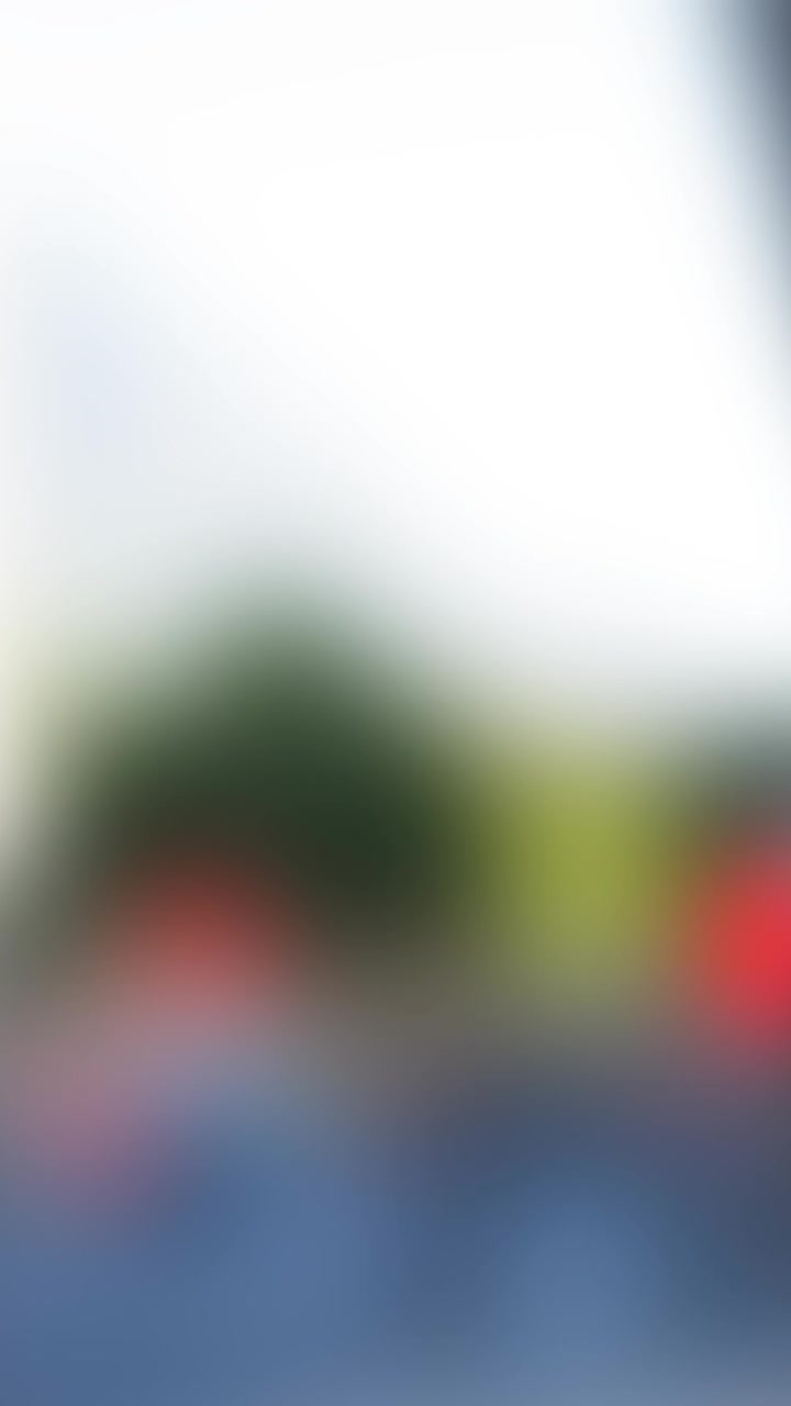 House-shaped keychain with keys animation over blurred urban background