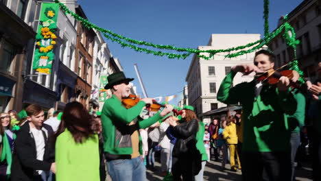 st. patrick's day street celebration with musicians and crowd