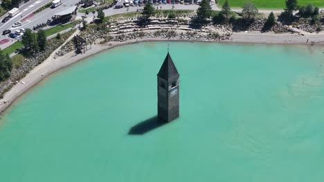 remains of the flooded curon venosta vecchia church, rising above the surface is a tourist attraction