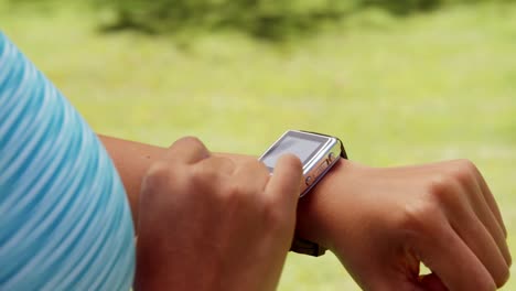 sportswoman touching her smart watch