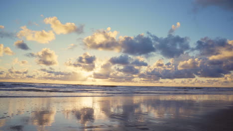 view of the beach at sunset on a summer night, shot close to the surf