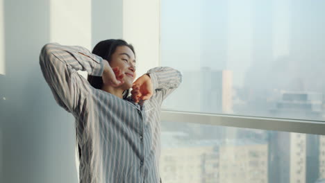 woman stretching by the window