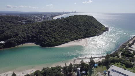 aerial view of burleigh head national park and tallebudgera creek bridge with cars traveling in gold coast, qld australia