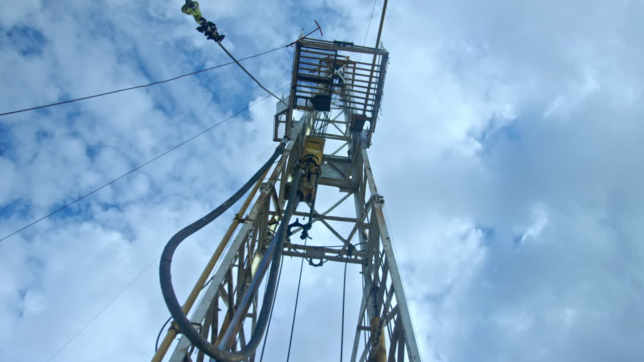 High metal support with the equipment for drilling. Gas and oil production concept. Low angle view.