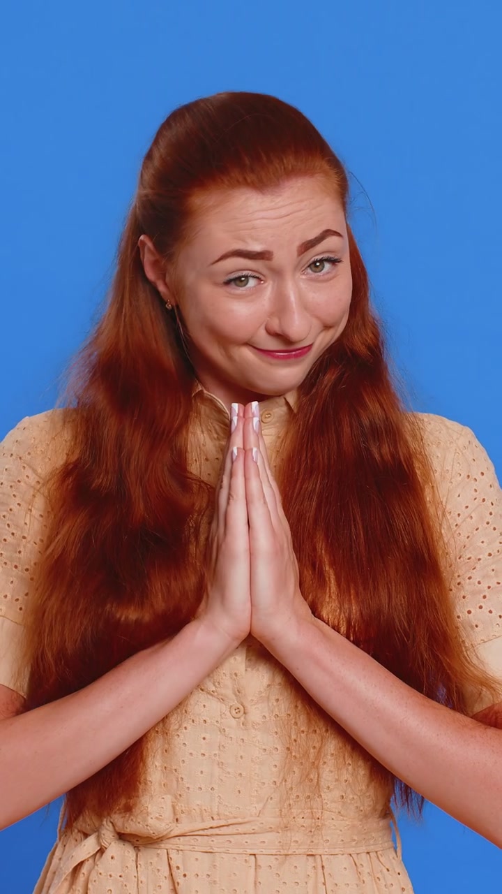 Attractive woman praying looking upward making wish begging apology asking help forgive me