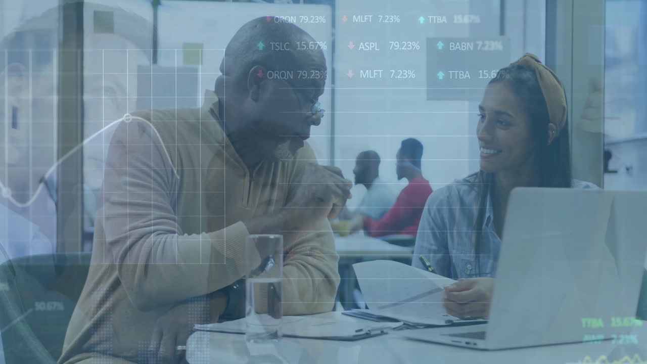 Animation of graphs and trading boards over diverse coworkers discussing reports on desk