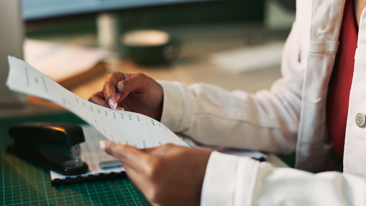 Woman reading paperwork at her desk
