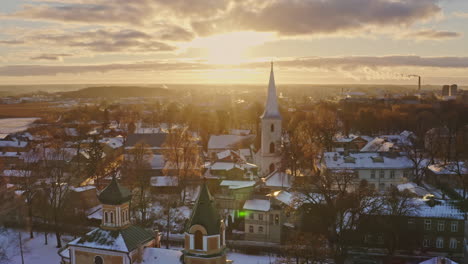 magnificent aerial of an orthodox and lutheran church in golden winter sunlight