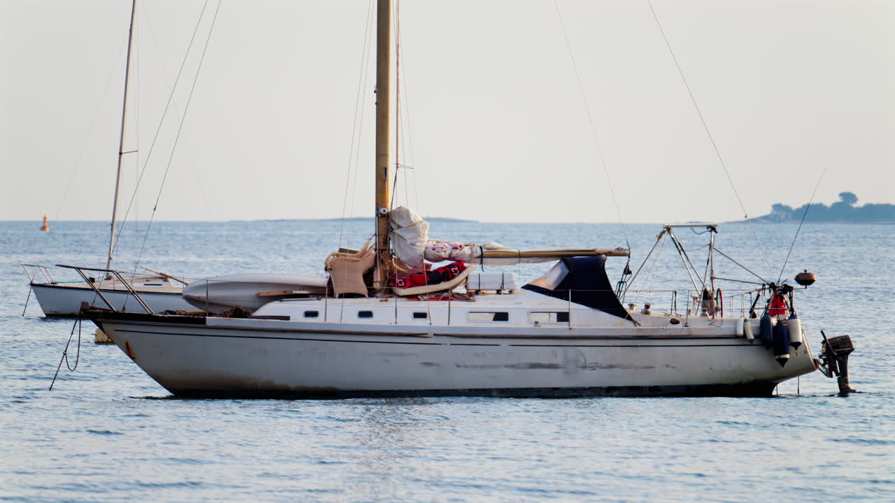 White boat docked on the sea on a cloudy day