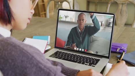 Composition-of-asian-schoolgirl-on-laptop-online-learning-with-african-american-schoolboy