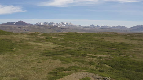 panorama of the green field and the snowcapped volcano of snaefellsjokull in snaefellsnes, iceland