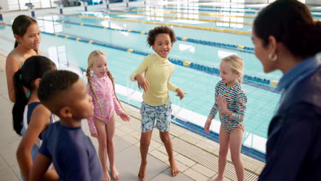 children with instructor at a swimming pool
