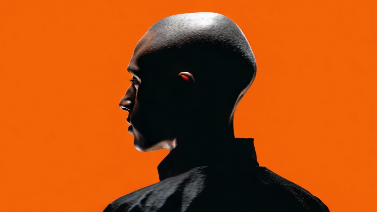 A Striking Visual Contrast: Exploring Identity and Expression Through the Bold Orange Background and Silhouette of a Subject's Head and Shoulders