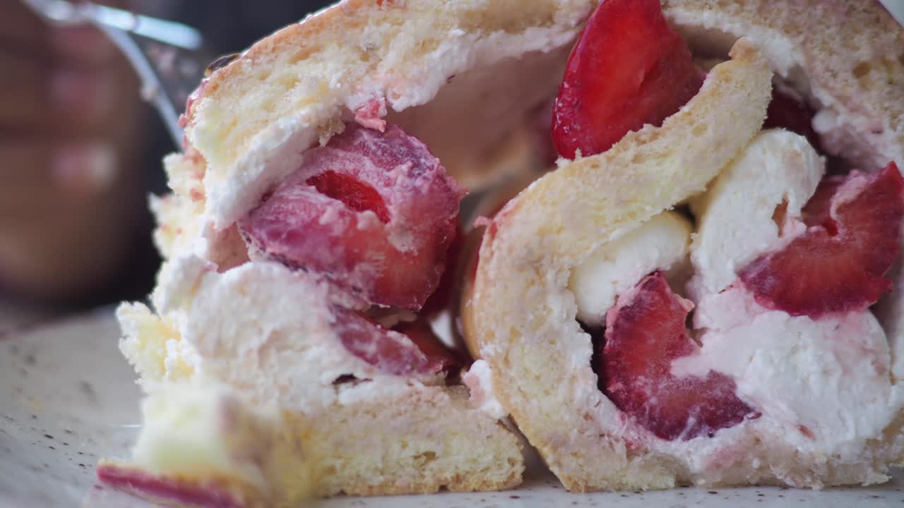 Close-up of a Swiss roll with strawberries