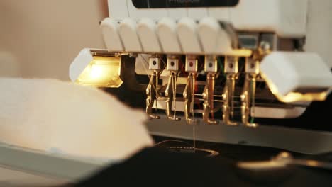 the automatic embroidery machine is working at high speed. close-up