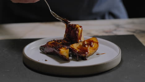 slow motion shot of a chef plating a gourmet sweet potato dish in a restaurant