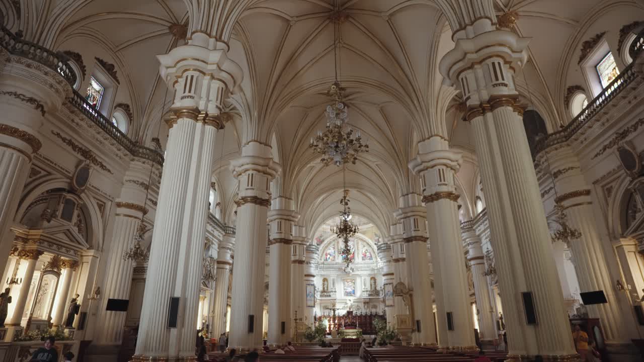 Interior of a grand church with ornate pillars and chandeliers