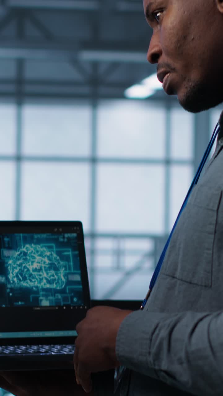 Vertical video IT expert coding on notebook in server room using artificial intelligence