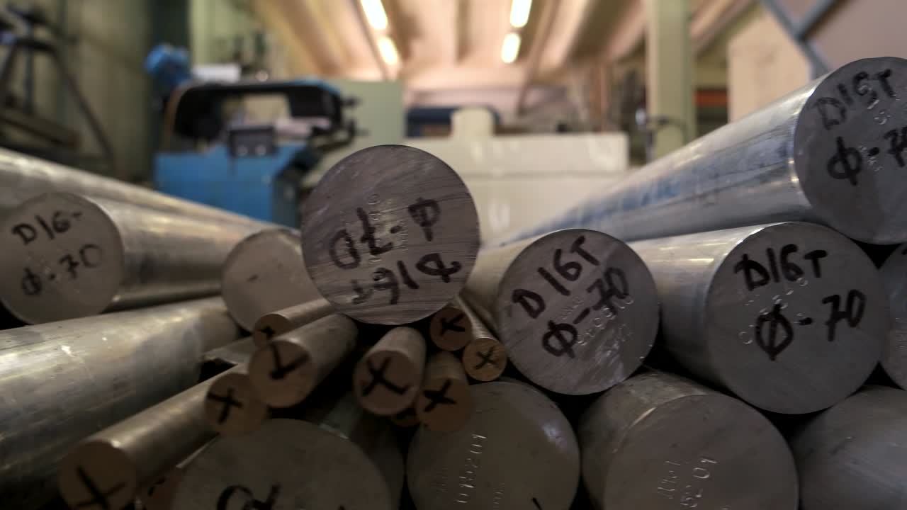 Stack of metal cylinders. Gray metallic tubes close up. Buy aluminium online.