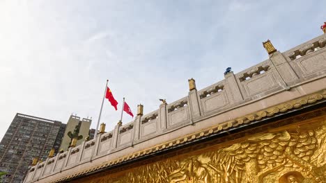 flags waving atop ornate temple structure