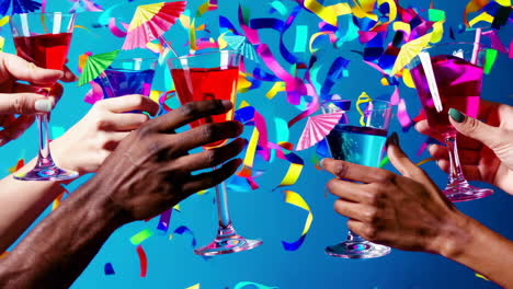 people toasting with colorful drinks and confetti