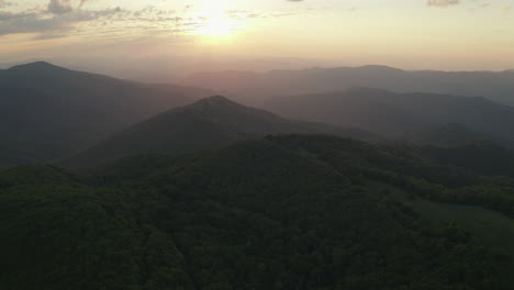 aerial parallax of morning sunrise over wooded appalachian mountains