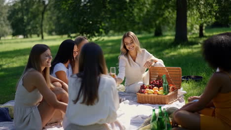 women enjoying a summer picnic in a park