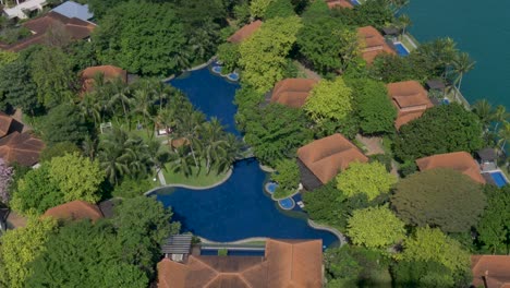 Vista-Panorámica-En-Cámara-Lenta-De-Piscinas-Y-Edificios-De-Villas-Turísticas-En-El-Parque-Acuático-Adventure-Cove-En-La-Isla-Sentosa,-Singapur,-Ciudad-Asia