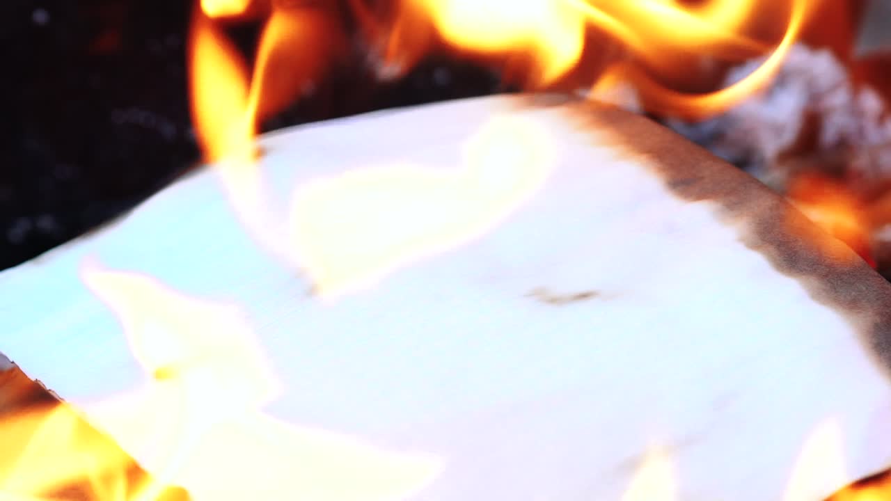 Flame when burning the paper in the bonfire. Paper in the Fire