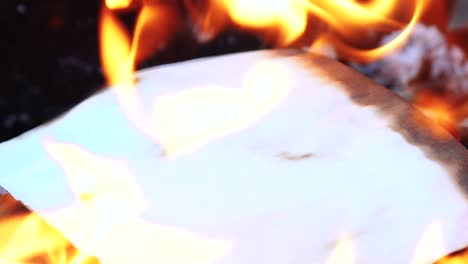 flame when burning the paper in the bonfire. paper in the fire