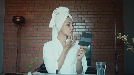 woman applying facial mask and getting ready
