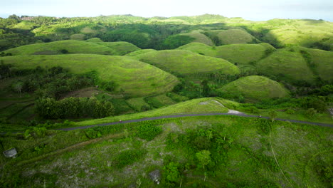 Through-before-Bali-rural-landscape,-small-scooter-travelling-alone