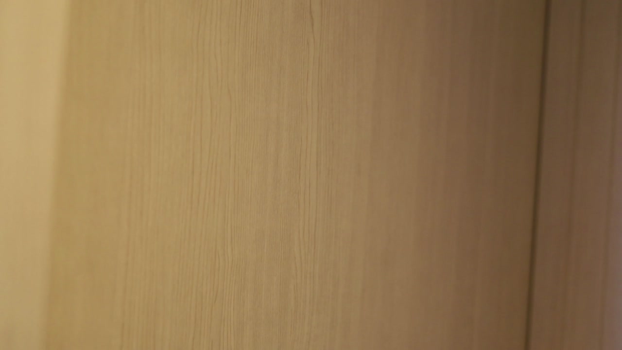 Man's hand knocking at the hotel's door with his knuckles