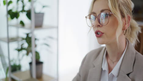 close-up of woman's face with glasses during business meeting