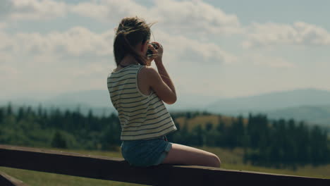 young girl photographer shooting landscape young photographer shooting landscape on beautifull green hillway taking pictures of nature girl filling the portfolio with amazing photos spending leisure time outdoor slow motion