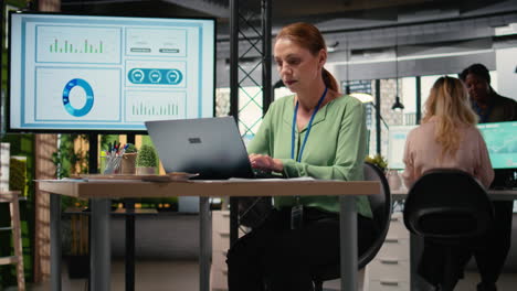 vertical video general director alone at her desk crafts a detailed business strategy